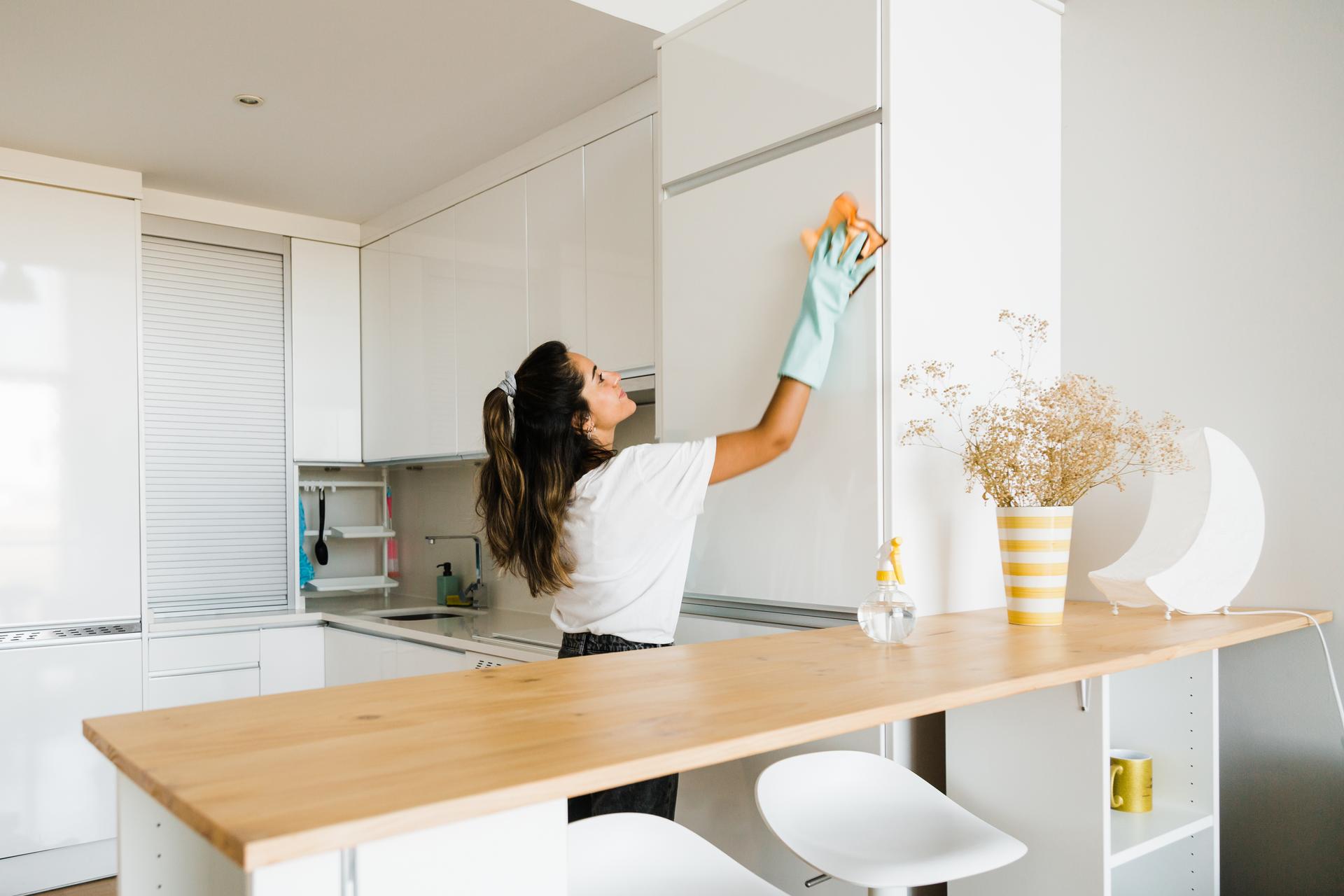 young woman cleaning her apartment